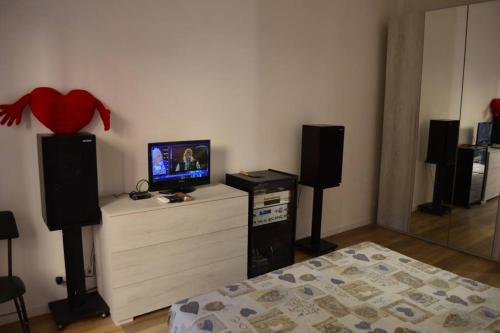 a bedroom with a bed and two speakers and a tv at Belvedere di Ancona in Ancona
