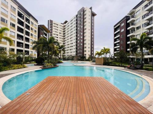 a large swimming pool with buildings in the background at I Best Value Studio in Iloilo City