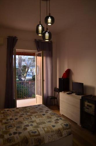 a bedroom with a bed and a door to a balcony at Belvedere di Ancona in Ancona