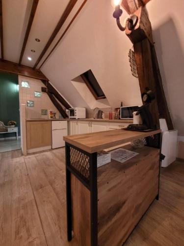 a kitchen with a wooden table in a room at Au 1894 Loft in Avize