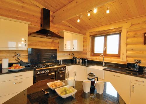 a kitchen with a stove and a counter top at Laxfield Lodges in Laxfield