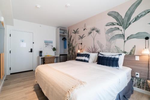 1 dormitorio con 1 cama grande y un mural tropical en la pared en Casa Ocean, en Miami Beach
