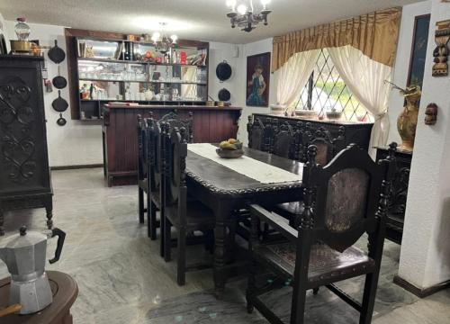 a dining room with a table and chairs at Hostería la Gaviota in Riobamba