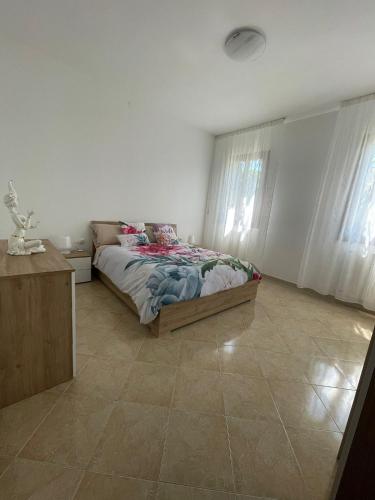a bedroom with a bed and a tiled floor at A Casa dei Nonni in Cavallino-Treporti