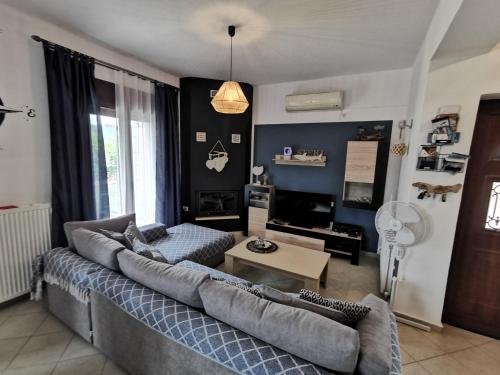 - un salon avec un canapé et une table dans l'établissement Villa Steki, à Roumelí