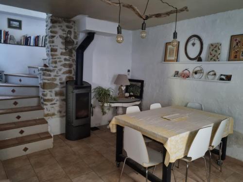 a dining room with a table and a wood stove at Gîte Maison provençale entre Aix et Marseille in Gardanne