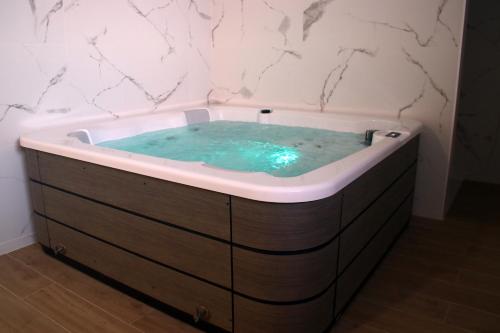 a bathroom with a tub with blue water in it at Tossa Beach Center in Tossa de Mar