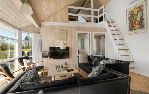a living room with a black couch and a loft at Stunning Home In Knebel With Sauna in Knebel
