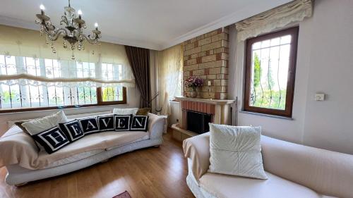 a living room with a couch and a fireplace at Heaven Garden Villa in Trabzon