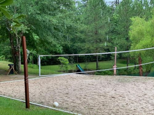 a volleyball court with a net in a park at West Wing at the Manor in Montgomery
