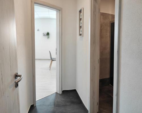 a hallway with a door leading into a room at Hotel Slobi in Štúrovo