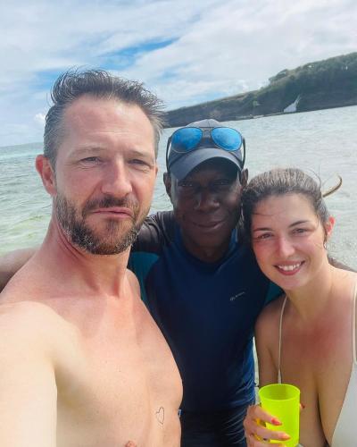 two men and a woman posing for a picture on the beach at VILLA CAPACITE 6 PERSONNES PROCHE PLAGES DU Sud in Rivière-Pilote