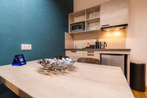 a kitchen with a wooden table with a bowl on it at EA ApartHotel Melantrich in Prague