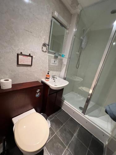 a bathroom with a toilet and a sink and a shower at Georgian House Hotel in Derby