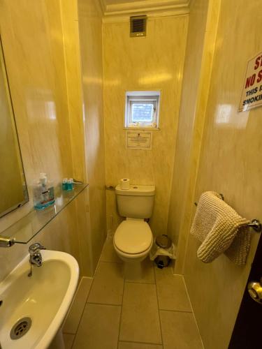 a small bathroom with a toilet and a sink at Georgian House Hotel in Derby