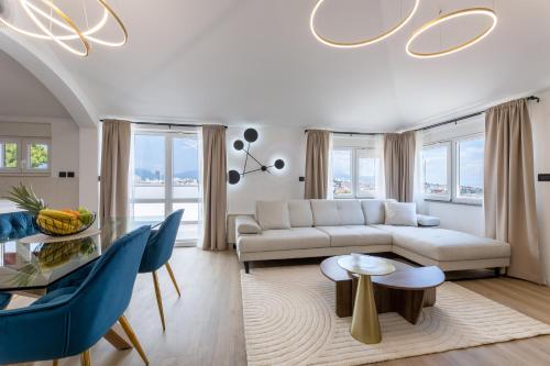 a living room with a white couch and a glass table at Apartment Aurelius in Split