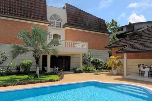 a house with a swimming pool in front of it at Residence Eburnea in Abidjan