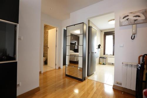 a hallway with a mirror and a room with a bed at Vivienda Turística Lore Artian. in Laguardia