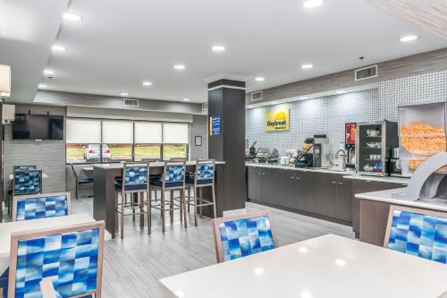 a fast food restaurant with chairs and a counter at Days Inn & Suites by Wyndham Prattville-Montgomery in Prattville