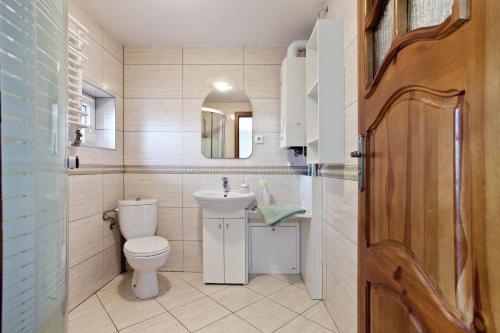 a bathroom with a toilet and a sink and a mirror at Baltiq Spot Rewa in Rewa