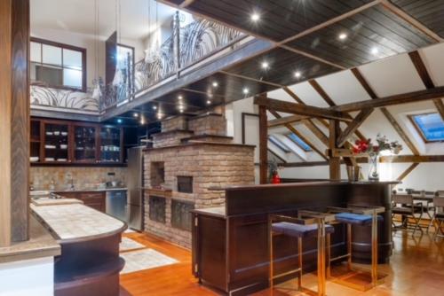 a large kitchen with a stone fireplace in a room at Penthouse Sky in Sarajevo