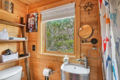a bathroom with a sink and a window at Arbor House of Dripping Springs - Hound Hollow in Dripping Springs