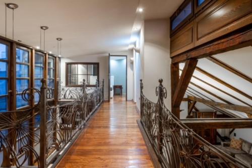 a hallway with wooden floors and wooden railings in a building at Penthouse Sky in Sarajevo