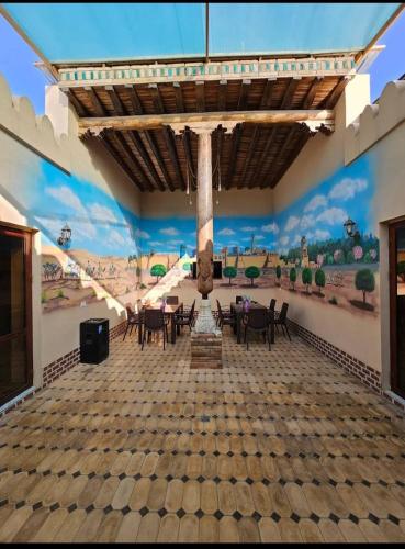 a dining room with a mural on the wall at Khiva Khan Hotel in Khiva