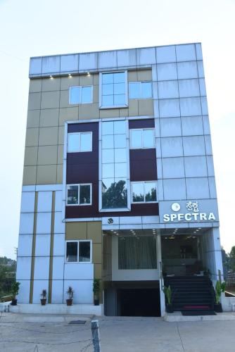 a building with a sign on the front of it at Spectra Hotel Bangalore Airport in Bengaluru