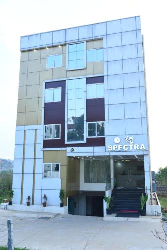 a building with a sign on the front of it at Spectra Hotel Bangalore Airport in Bengaluru