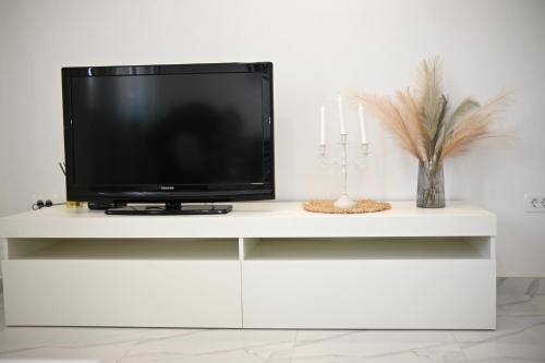 a tv sitting on a white entertainment center at Golden Neretva apartments in Metković