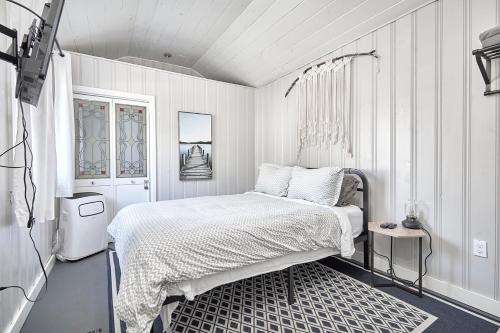 a white bedroom with a bed and a window at Muskoka Getaway-Trails/Hot Tub/Hike/Fish/Ski/Relax in Honey Harbor