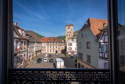 a view from a window of a city street at Logis Hôtel de la Tour in Ribeauvillé