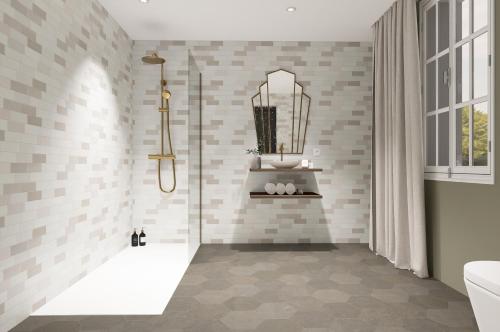 a bathroom with a shower with white tiles at Grand Hôtel de la Scala in Calacuccia