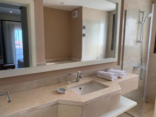 a bathroom with a sink and a large mirror at Luxurious Villa with Infinity Private Pool & Jacuzzi over Sabina Island's Lagoon in Hurghada