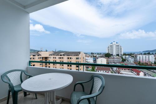 a balcony with a table and chairs and a view of a city at Condopatong in Patong Beach