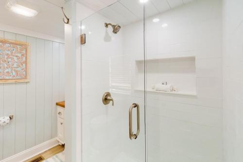 a shower with a glass door in a bathroom at Jewel's Cottage in Demere Park