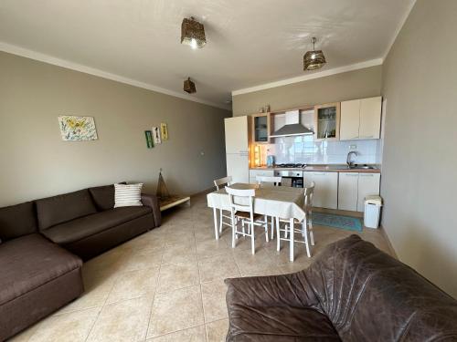 a living room with a couch and a table and a kitchen at sea View Nautilus free wi-fi Sal Rei in Sal Rei