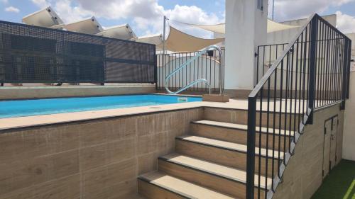 a house with a swimming pool and stairs at Sepúlveda, tranquilo y con piscina by OUTIN in Seville