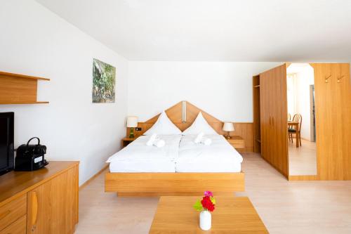 a hotel room with a bed and a table at Fewo Schneckenhalde App 12 in Bad Säckingen