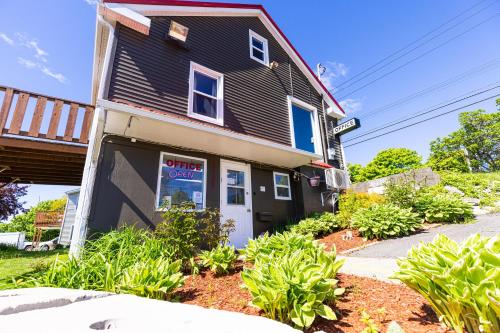 a house with a sale sign in the front of it at Hillside Motel in Saint John