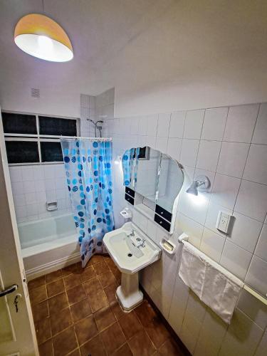 a bathroom with a sink and a mirror at Qaway in Salta