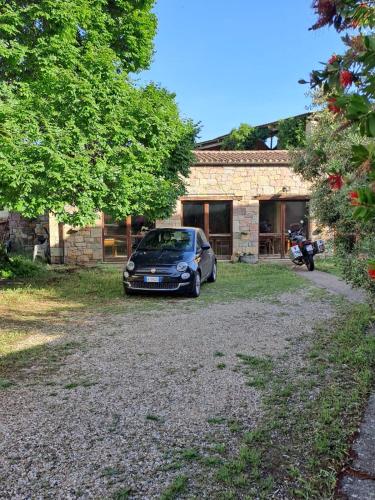 a car parked in front of a house at B&B S'Omu Antiga in Nureci