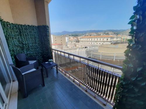 a balcony with chairs and a view of a city at U Baruni B&B in Messina
