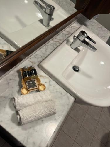 a bathroom sink with a cell phone and a towel at Casa Sole in Morgex