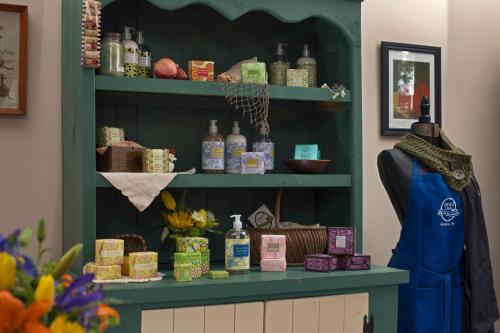 a store with a green shelf with bottles on it at 1825 Inn Bed and Breakfast in Palmyra