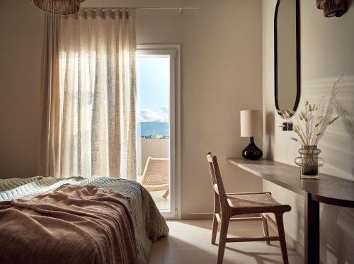 a bedroom with a bed and a desk and a window at Conte Gesto Villa, with Heated Pool, By ThinkVilla in Akrotiri