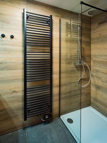 a shower with a glass door in a bathroom at Welldone Resort / Cozy Wine in Nieuwerkerken