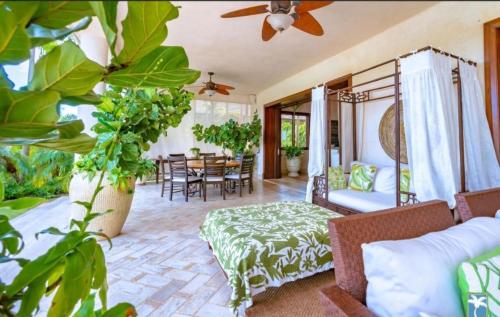 a living room with a bed and a dining room at Holiday Villa 27 in La Romana