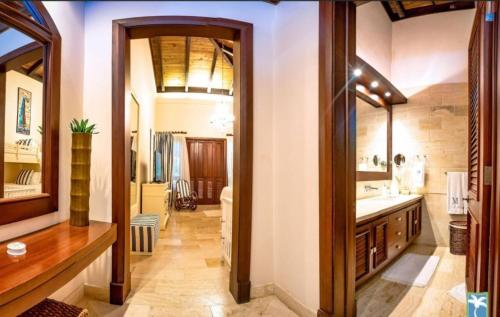 a bathroom with a sink and a mirror at Holiday Villa 27 in La Romana